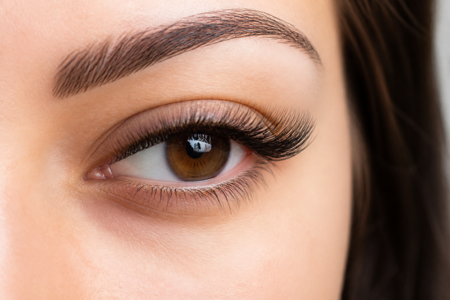 Eyelash Fill Maintenance: 6 Ultimate Tips for Lasting Beauty 3 A close-up, high-resolution shot of stunning, long lash extensions being gently brushed with a soft lash spoolie, emphasizing proper eyelash fill maintenance. The background is a clean, bright beauty salon setting, 16:9 aspect ratio.